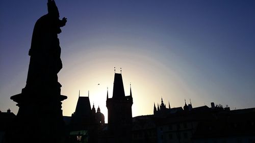 Low angle view of silhouette buildings against sky