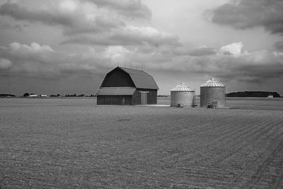 Built structure on field against sky