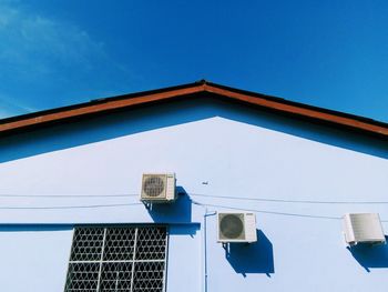 Low angle view of building against clear blue sky