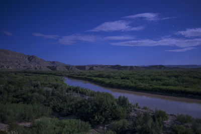 Scenic view of lake against sky at night