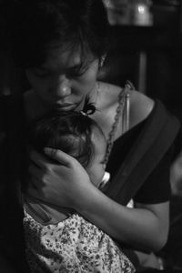 Close-up of girl holding baby at home