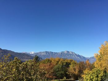 Scenic view of mountains against clear blue sky