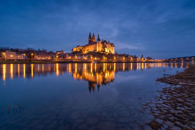 Reflection of buildings in water at night