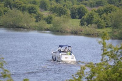 Boat in lake against trees