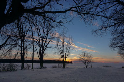 Snow covered landscape at sunset