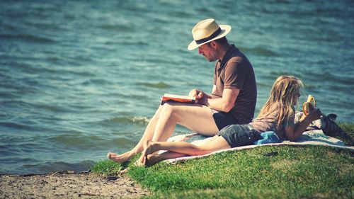 Rear view of couple sitting on land