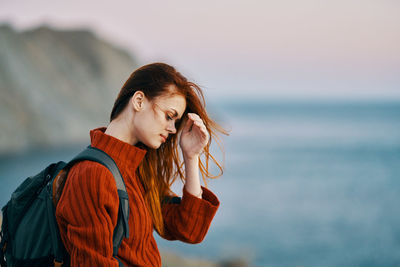 Portrait of young woman looking at sea