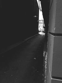 Wet road by wall in city