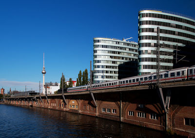 Low angle view of modern buildings against blue sky