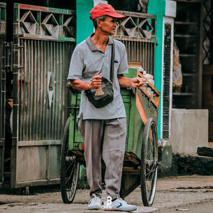 Full length of man holding bicycle