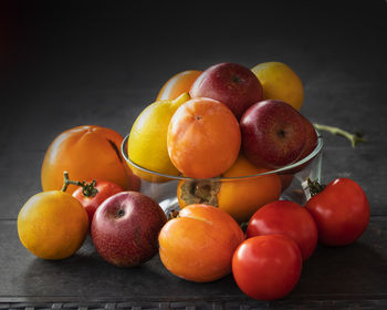 Close-up of apples on table against orange background