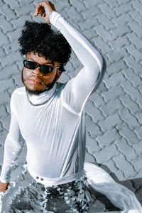 Portrait of young man wearing sunglasses standing outdoors