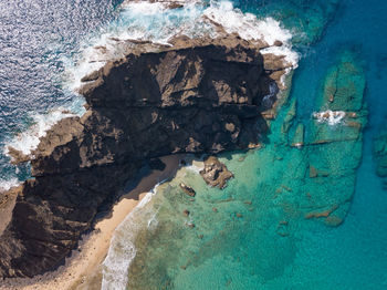 High angle view of rock and sea