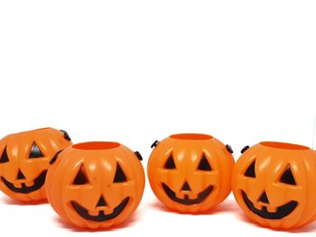 Close-up of pumpkins against orange background