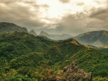 Scenic view of mountains against cloudy sky