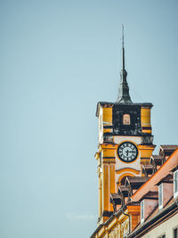 Low angle view of clock tower against clear sky