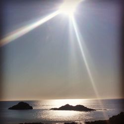Scenic view of sea against sky on sunny day