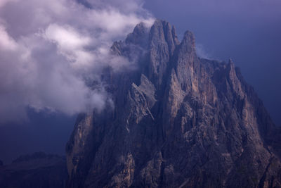 Scenic view of dolomites rocky mountains against sky and clouds