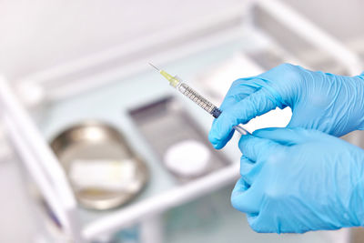 Cropped hand of scientist examining chemical in laboratory