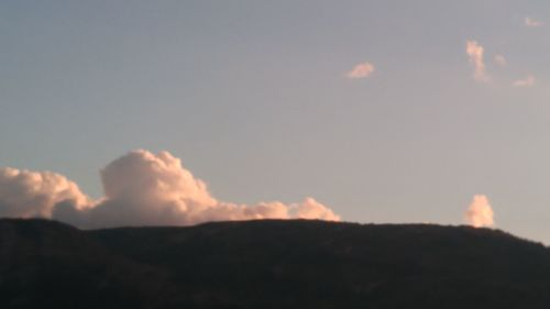 Scenic view of mountains against sky at sunset