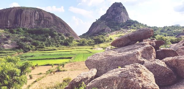 Panoramic view of rocks on landscape against sky