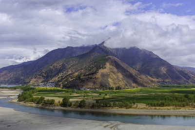 Scenic view of mountains against cloudy sky