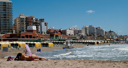 Man on beach against clear sky