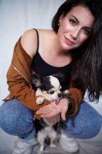 Portrait of young woman with dog