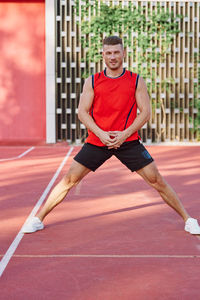 Portrait of young woman exercising on court