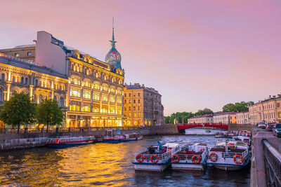 View of boats in river against buildings