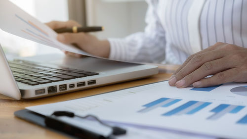 Midsection of woman working on table