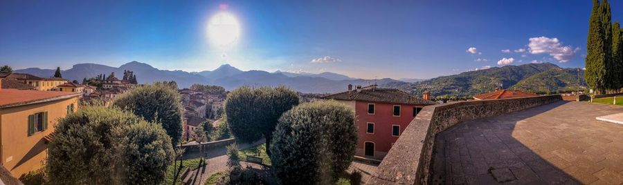 Panoramic view of buildings and mountains against sky