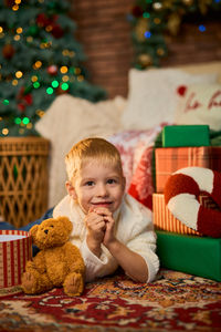 Portrait of cute baby girl sitting on sofa at home