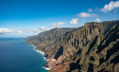 Scenic view of sea and mountains against sky