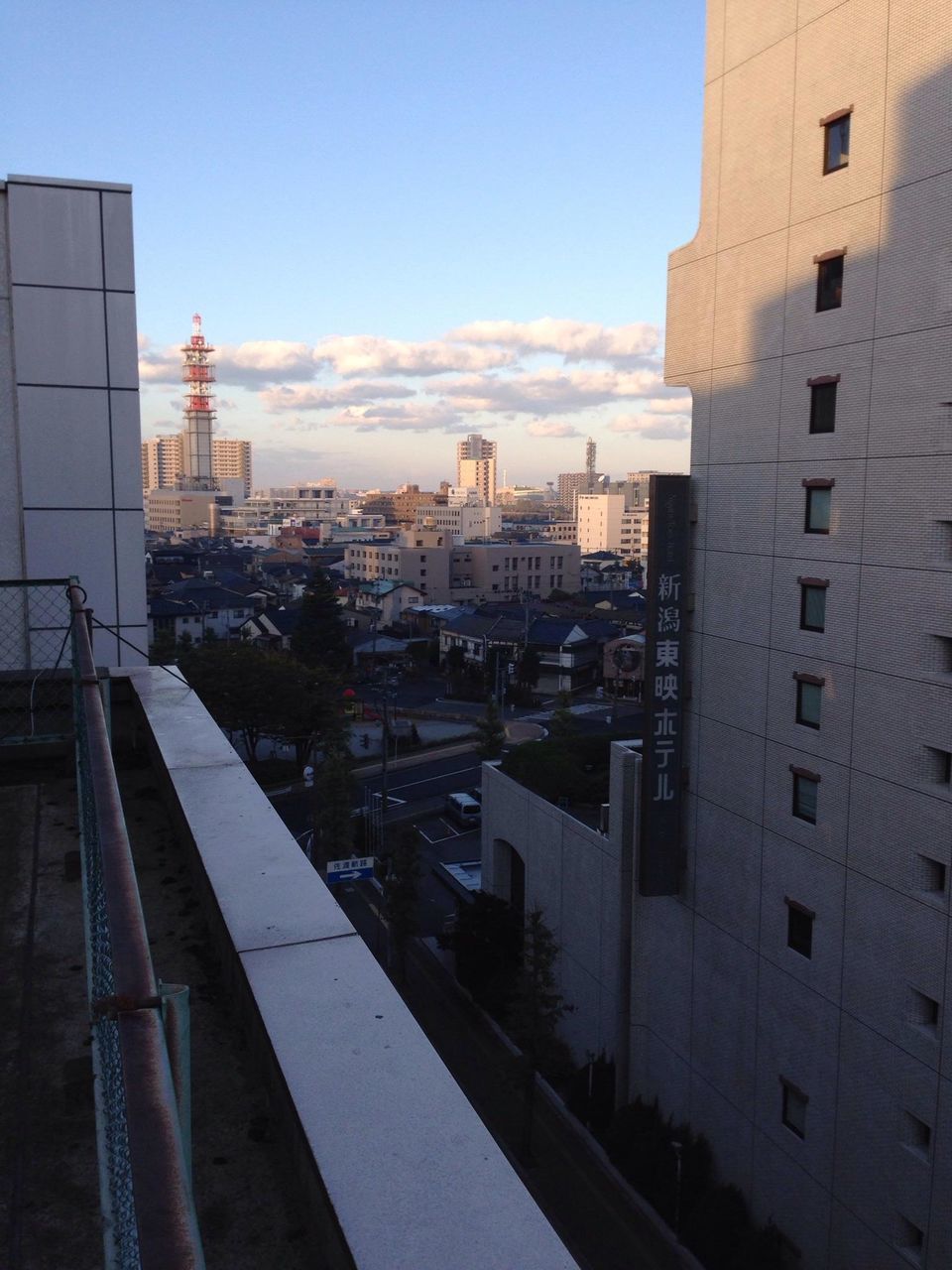 building exterior, architecture, built structure, city, sky, residential building, residential structure, cityscape, building, sunset, residential district, sunlight, railing, outdoors, no people, high angle view, city life, house, day, transportation