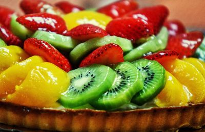 Close-up of fruits on tart at table