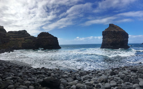 Rocks in sea against sky