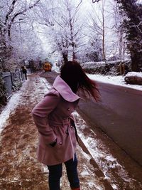 Woman standing on snow covered landscape