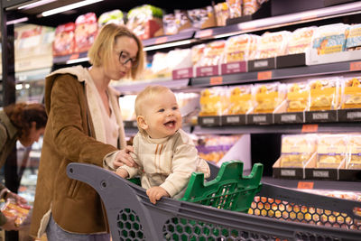 Portrait of smiling young woman standing in store