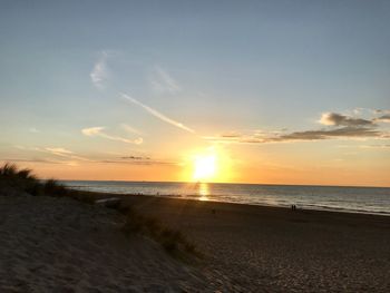 Scenic view of beach against sky during sunset