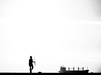 Silhouette man standing against clear sky