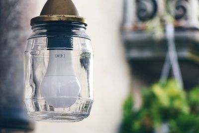 Close-up of light bulb hanging outdoors