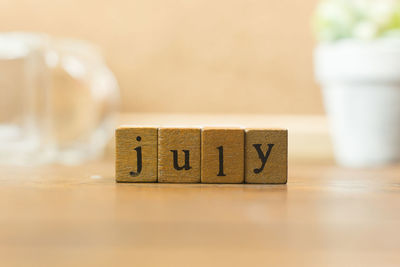 Close-up of july text on table