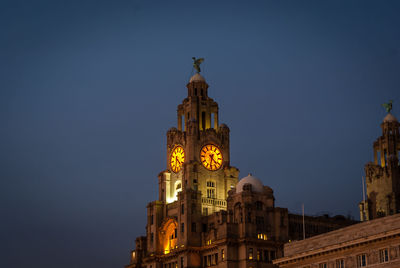 Low angle view of clock tower against clear sky