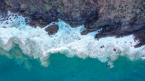 Incredible view rocks and sea. white wave foam crashes against the rocks. nusa penida, indonesia