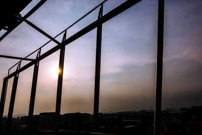 Silhouette buildings against sky during sunset