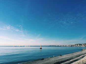 Scenic view of sea against blue sky
