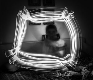 Blur boy seen through framed light painting