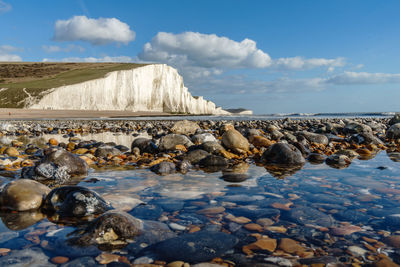 Rocks on beach against sky