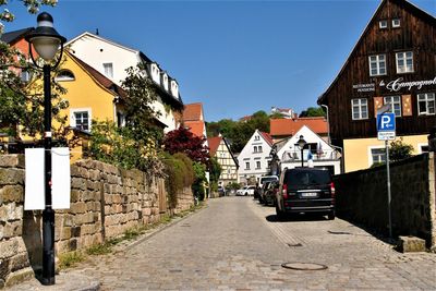 Street amidst buildings against sky in city